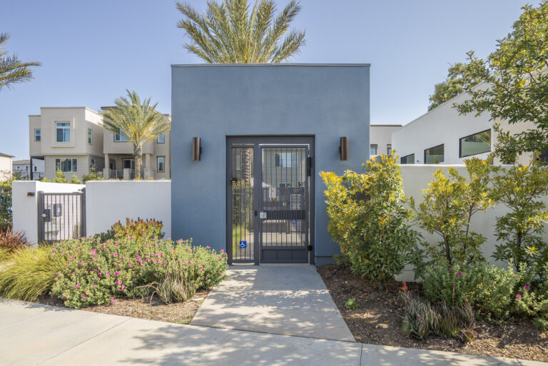 Stylish and welcoming entrance with well-lit pathways and lush landscaping.